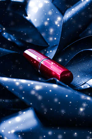 Red lipstick on blue silk and shiny glitter background, luxury make-up and beauty cosmeticsの写真素材