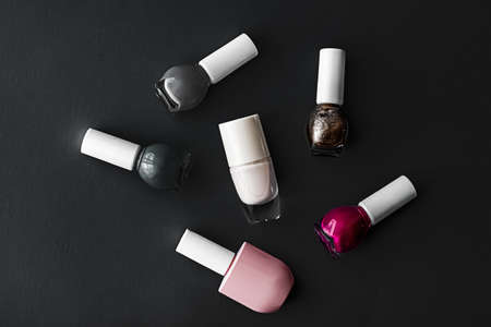 Nail polish bottles on black background.の写真素材