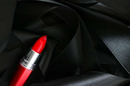 Red lipstick on black silk background, luxury make-up and beauty cosmeticsの写真素材