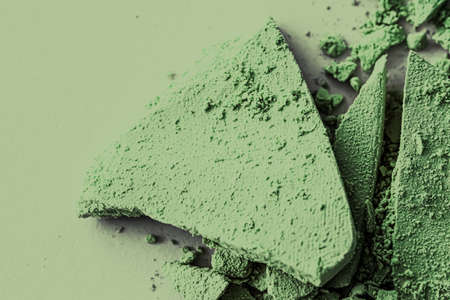 Green eye shadow powder as makeup palette closeup, crushed cosmetics and beauty textures