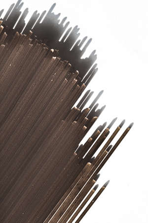 Black raw whole grain spaghetti, italian pasta as organic food ingredient, macro product and cook...