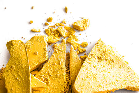 Yellow eye shadow powder as makeup palette closeup isolated on white background, crushed cosmetics and beauty texturesの写真素材