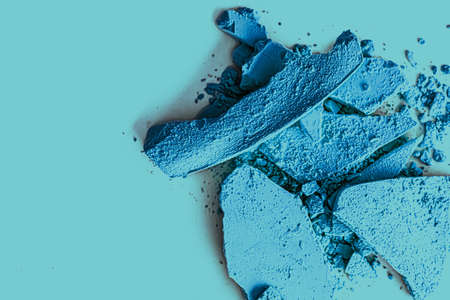Blue eye shadow powder as makeup palette closeup, crushed cosmetics and beauty textures