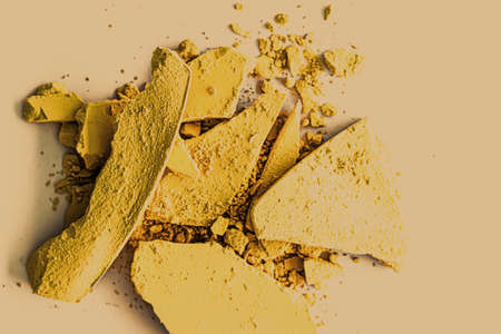 Yellow eye shadow powder as makeup palette closeup, crushed cosmetics and beauty textures