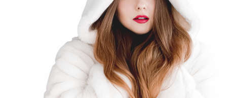 Young woman in fluffy fur coat with hood wrap, warm winter clothing for fashion and Christmas...