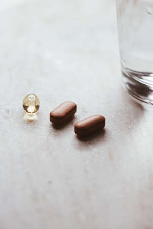 Medical pills and glass of water, health and wellness closeupの写真素材