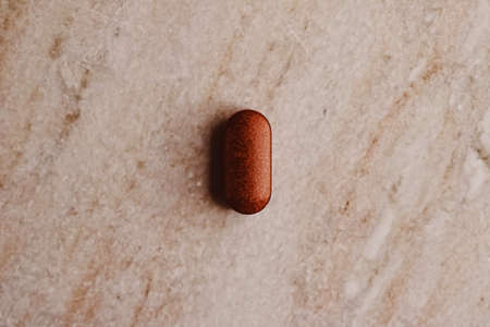 Medical pill on stone background, health and wellness closeupの写真素材