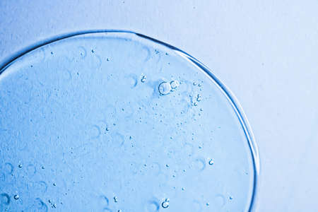Blue gel texture on glass as cosmetics background, hygiene and science closeup