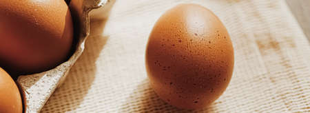 organic farm eggs in egg box and rustic cloth napkins