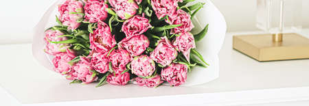 Bouquet of fresh cut pink tulips in an elegant interior, home decorの写真素材