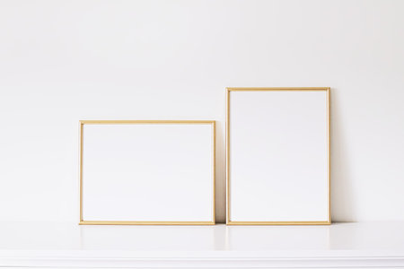 Two golden vertical and horizontal frames on white furniture, luxury home decor and design for mockup creationの写真素材
