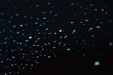 Liquid water drops on glass surface, abstract backdrop and science background