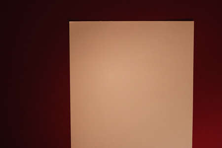 Beige A4 paper on dark red background as office stationery flatlay, luxury branding flat lay and brand identity design for mockupの写真素材