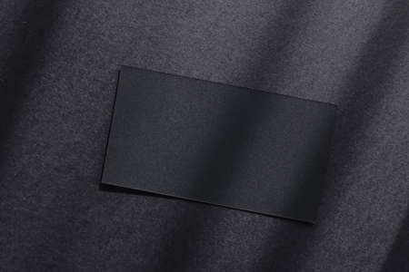 Black business card on dark flatlay background and sunlight shadows, luxury branding flat lay and brand identity design for mockupの写真素材