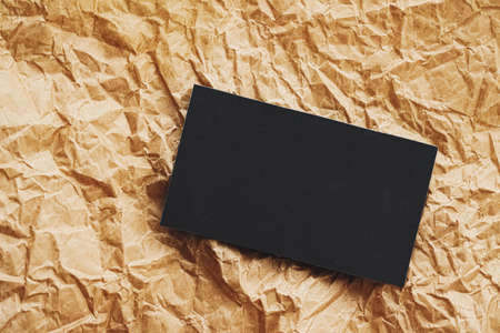 Black business card flatlay on brown parchment paper background, luxury branding flat lay and brand...