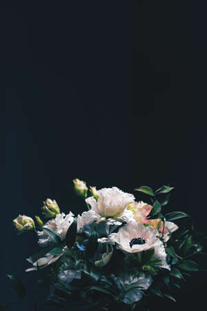 Flower bouquet on black background, beautiful floral arrangement, creative flowers and floristic design ideaの写真素材