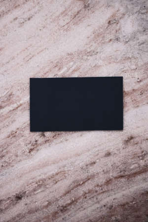 Black business card flatlay on stone background, luxury branding flat lay and brand identity design for mockupの写真素材