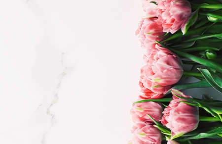 Spring flowers on marble background as holiday gift, greeting card and floral flatlayの写真素材
