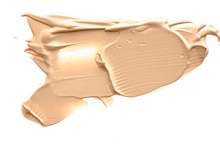 Beige beauty cosmetic texture isolated on white background, smudged makeup emulsion cream smear or foundation smudge, crushed cosmetics product and paint strokesの写真素材