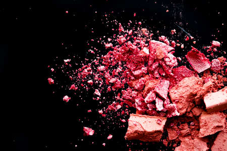 Crushed cosmetics, mineral organic eyeshadow, blush and cosmetic powder isolated on black background, makeup and beauty banner, flatlay designの写真素材