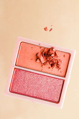 Eyeshadow powder or blush makeup palette as flat lay isolated on golden background, beauty eye...