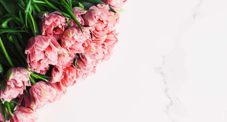 Spring flowers on marble background as holiday gift, greeting card and floral flatlayの写真素材