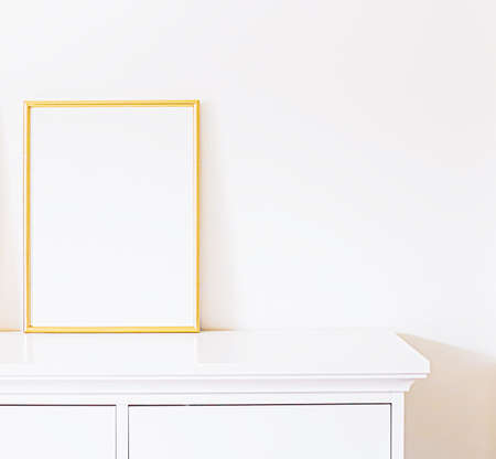 Golden frame on white furniture, luxury home decor and design for mockup, poster print and printable art, online shop showcaseの写真素材