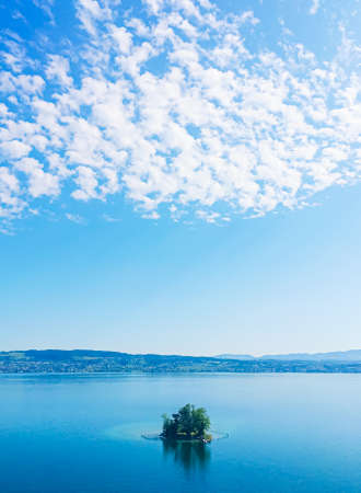 Idyllic Swiss landscape, view of lake Zurich in Wollerau, canton of Schwyz in Switzerland, Zurichsee, mountains, blue water, sky as summer nature and travel destination, ideal as scenic art printの写真素材