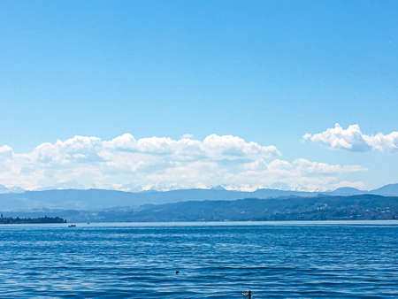 Idyllic Swiss landscape, view of lake Zurichsee in Zurich, Switzerland, mountains, blue water, sky as summer nature and travel destination, ideal as scenic art printの写真素材