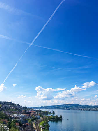 Idyllic Swiss landscape, view of lake Zurich in Richterswil, Switzerland, mountains, blue water of Zurichsee, sky as summer nature and travel destination, ideal as scenic art printの写真素材
