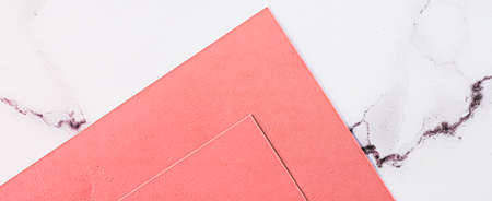 Pink A4 papers on white marble background as office stationery flatlay, luxury branding flat lay and...