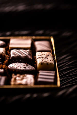 Swiss chocolates in gift box, various luxury pralines made of dark and milk organic chocolate in chocolaterie in Switzerland, sweet dessert food as holiday present and premium confectionery brand.の写真素材