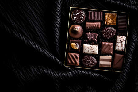 Swiss chocolates in gift box, various luxury pralines made of dark and milk organic chocolate in...