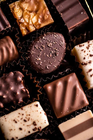 Swiss chocolates in gift box, various luxury pralines made of dark and milk organic chocolate in...