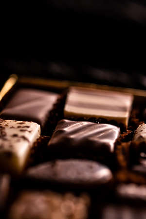 Swiss chocolates in gift box, various luxury pralines made of dark and milk organic chocolate in chocolaterie in Switzerland, sweet dessert food as holiday present and premium confectionery brandの写真素材