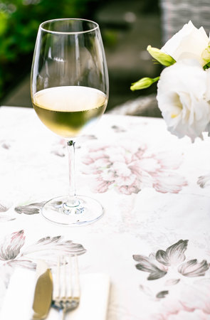 White wine in luxury restaurant on summer garden terrace, wine tasting experience at winery in the vineyard, gourmet tour and holiday travelの写真素材