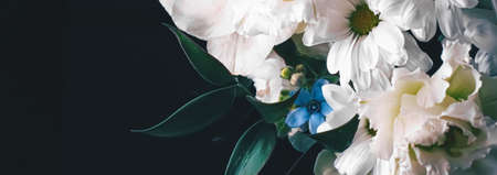 Flower bouquet on black background, beautiful floral arrangement, creative flowers and floristic design ideaの写真素材