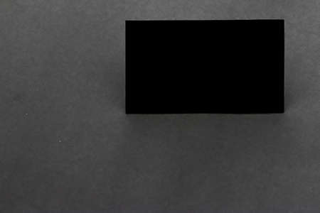 Black blank business card on dark gray backgroundの写真素材