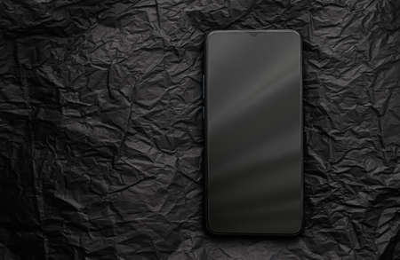 Minimalistic background with black mobile phone, smartphone mockup as app template and brand marketing designの写真素材
