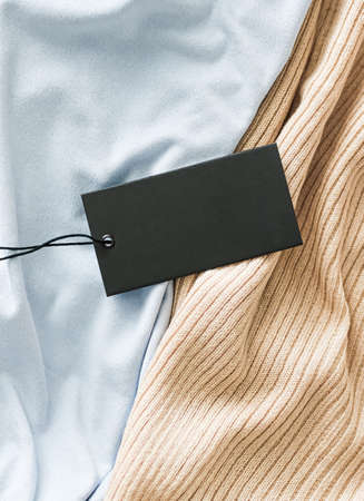 Horizontal clothing price tag on fabric background