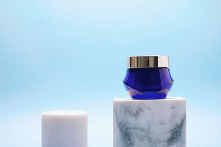 Facial cream jar on blue background, luxury skincare products, beauty and cosmeticsの写真素材