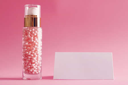 Skincare product and business card on pink background, beauty and cosmeticsの写真素材