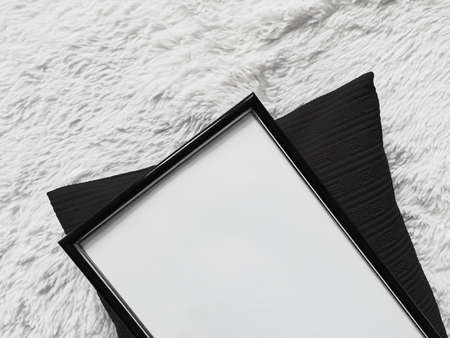 Thin wooden frame with blank copyspace as poster photo print mockup, black cushion pillow and fluffy...