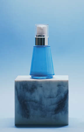Serum bottle on blue background, luxury skincare products, beauty and cosmeticsの写真素材