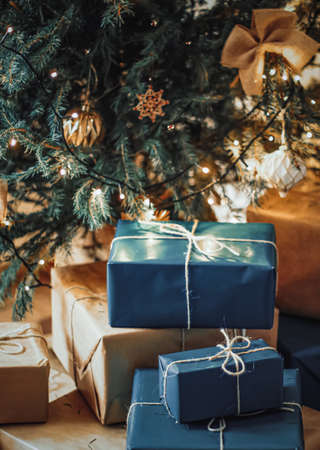 Christmas holiday delivery and sustainable gifts concept. Navy blue gift boxes wrapped in...
