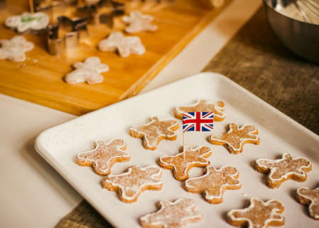 British holiday and Christmas baking concept. Union Jack flag of Great Britain and gingerbread men...