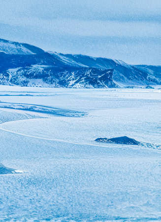Winter wonderland and Christmas fantasy landscape. Frozen sea coast and mountains covered with snow as holiday backgroundの写真素材