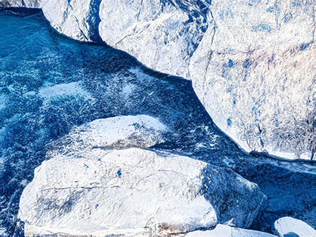 Winter wonderland and Christmas fantasy landscape. Frozen sea coast and mountains covered with snow as holiday backgroundの写真素材
