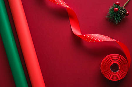 Christmas flatlay and holiday design concept. Decoration, ornament and xmas gift wrapping on red paper background as flat lay top viewの写真素材