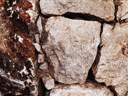 Stone texture and exterior design concept. Stonewall made of natural rocks as architectural surface backgroundの写真素材